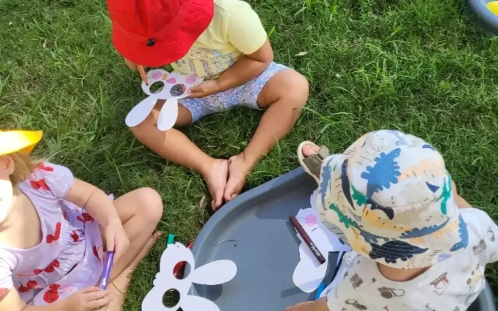 Preschoolers painting and doing arts and crafts in a classroom
