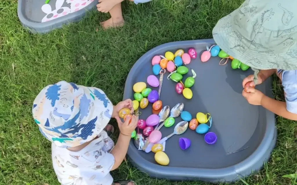 kids playing colorful Easter eggs during outdoor play